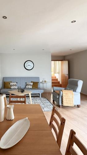 a living room with a table and a couch at Casa das Castanhas - Cinfães, Viseu in Cinfães
