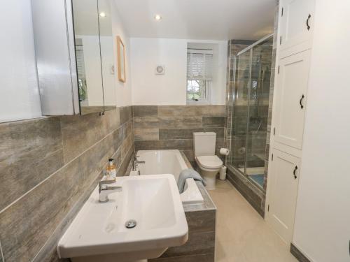 a bathroom with a sink and a toilet at Barley Cote Farm in Keighley