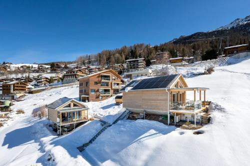 a group of houses in the snow at Tiny Barrhorn in Grächen