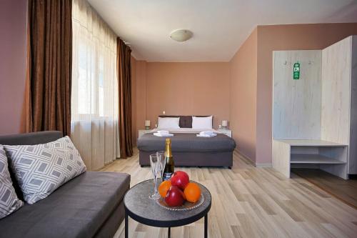 a living room with a couch and a bed at Hotel Leda in Sofia