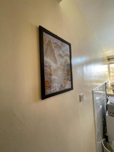 a picture hanging on a wall in a room at Cosy Loft Eldoret in Eldoret