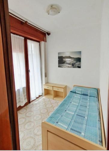 a bedroom with a bed and a desk in it at Giglio Gold in Giglio Porto