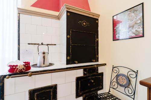 a kitchen with black and white tiling and a stove at Piazzetta San Giovanni Specchia in Specchia