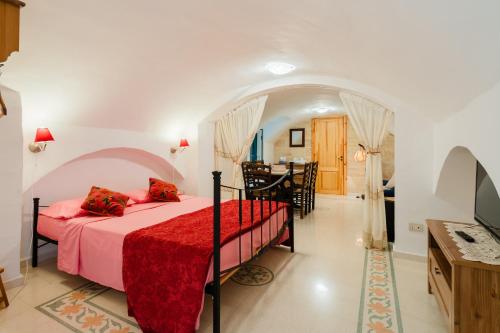 a bedroom with a bed and a dining room at Piazzetta San Giovanni Specchia in Specchia