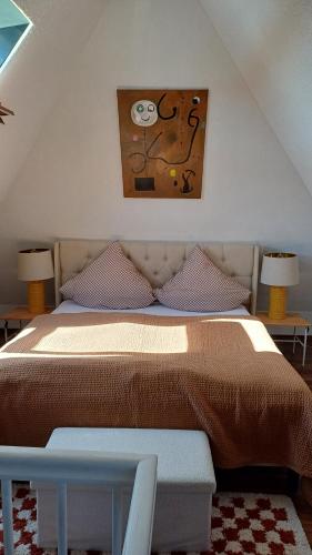 a bedroom with a bed with a picture on the wall at Blick auf den Magdalenenberg in Villingen-Schwenningen