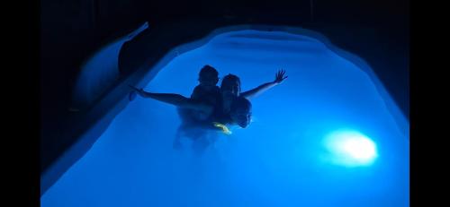 a man in a tunnel with a blue light at Cabaña Tu Refugio in Paraná