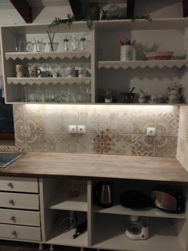 a kitchen with a wooden counter top and shelves at Vasileris Home in Moúdhros