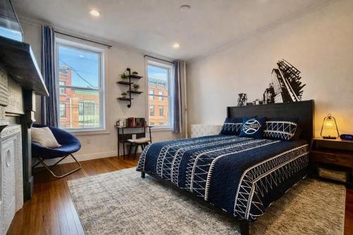 a bedroom with a bed and two windows at Large Home - Great Location - 15 Minutes to NYC in Hoboken