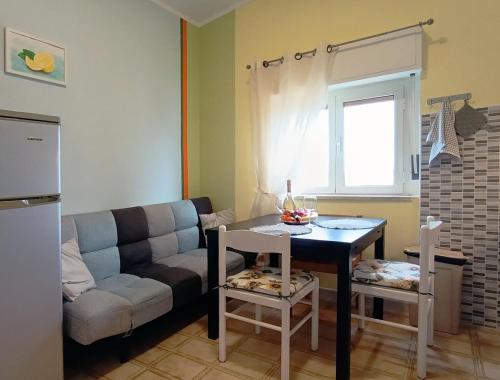a living room with a couch and a table at Casa Bonifacio in Scalea