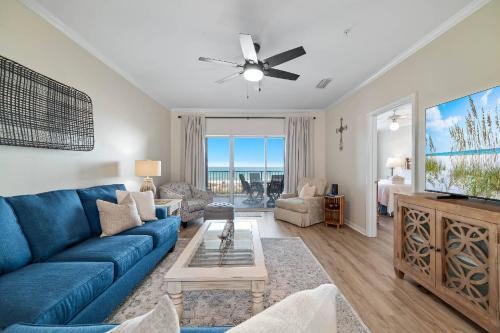 a living room with a blue couch and a tv at Marlin Key 1B in Orange Beach