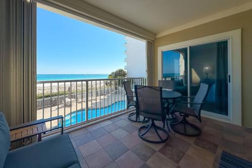 a balcony with a table and chairs and a view of the ocean at Marlin Key 1B in Orange Beach