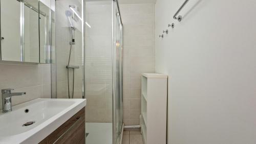 a bathroom with a sink and a shower at Residence les Pleiades in Flaine