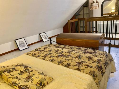 a bedroom with a bed and two pictures on the floor at La mansardina del mulino in Lodi