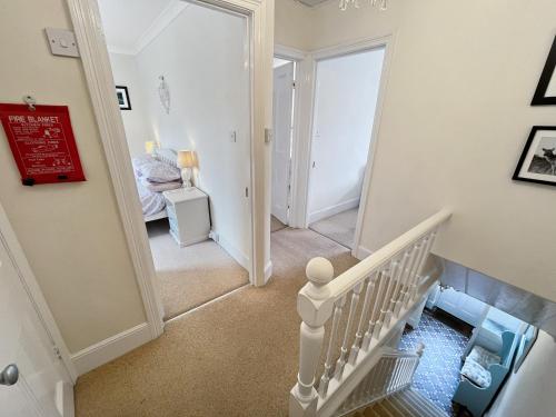 a hallway with a stairway leading to a bedroom at Pips Corner Lynton in Lynton
