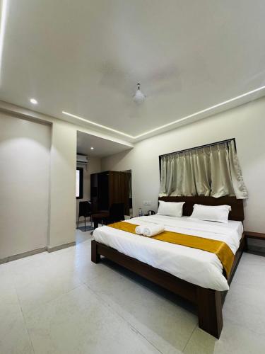 a bedroom with a large bed in a room at SeaYou Stay in Daman
