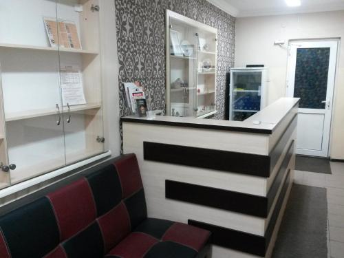 a bar in a restaurant with a red chair at Ulpan Mini Hotel in Astana