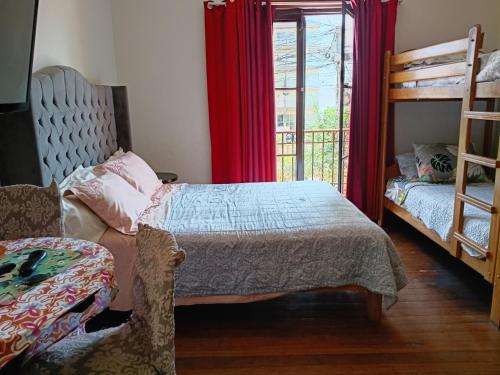 a bedroom with two bunk beds and a window at Hospedaje Marita in Lima