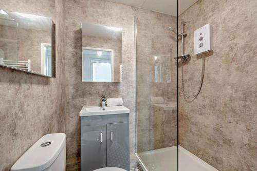 a bathroom with a shower and a toilet and a sink at 1 Bed in Putsborough oc-b28792 in Croyde
