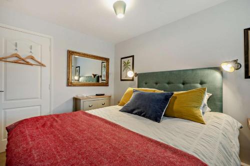 a bedroom with a large bed and a mirror at 1 Bed in Putsborough oc-b28792 in Croyde