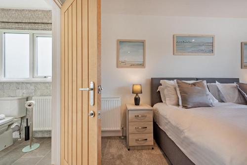 a bedroom with a bed and a nightstand and a window at 6 Bed in Llanarthney oc-c28878 in Llanarthney