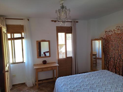 a bedroom with a bed and a mirror on the wall at Casa Madre Amada in Candelaria