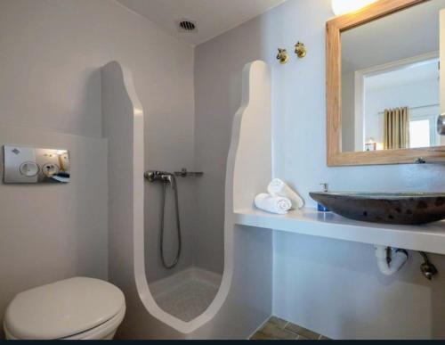 a bathroom with a sink and a toilet and a mirror at Naxos Diol in Naxos Chora