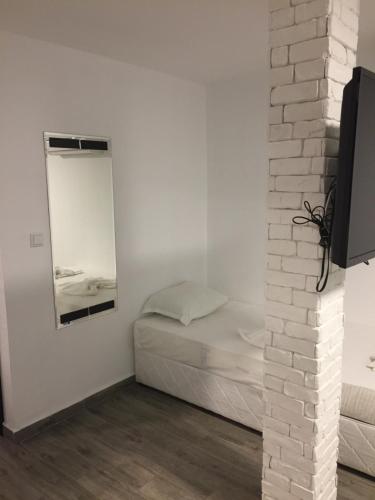 a small bedroom with a bed and a mirror at Fani 2 in Lozenets