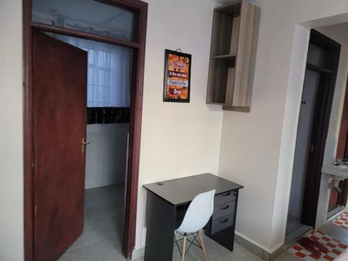 a desk with a white chair next to a door at Serenity Homes in Gatunga