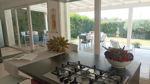 a kitchen with a counter top with a stove top oven at Salicornia - Sea view villa with pool in Marsala
