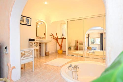 a large bathroom with a tub and a sink at Casa Matteu in Figari