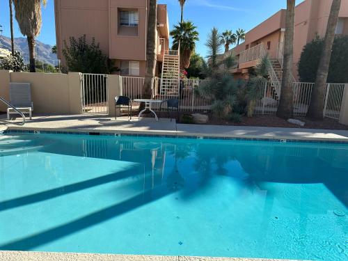 a swimming pool in front of a apartment complex at Flamingo Suites in Tucson