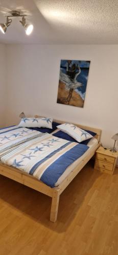 a bedroom with a bed with a painting on the wall at Burgblick in Kemnath
