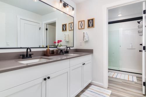a bathroom with white cabinets and a large mirror at Sunny Springs, Hurricane, Ut in Hurricane