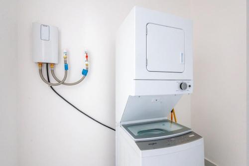 a machine is plugged into a wall in a bathroom at Elegant 3BD Condo in Cocotal in Punta Cana