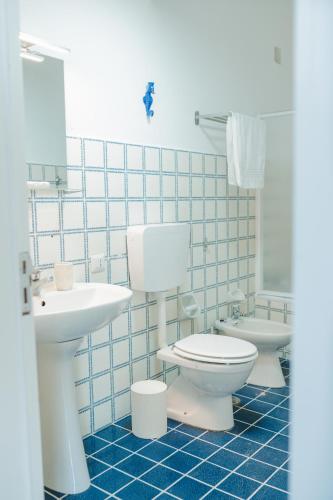 a bathroom with a white toilet and a sink at Casacasa Praiano in Praiano