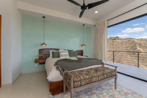 a bedroom with a bed and a large window at NEW! Oceanview, Infinity Pool, Spacious & Private Luxury Group Retreat in Potrero