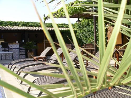 a row of chairs and tables on a patio at La Bergerie Du Cap in Cap d'Agde