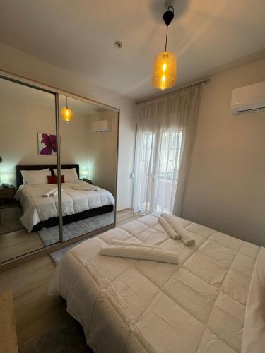 a bedroom with a large bed and a mirror at Katrin chios in Chios