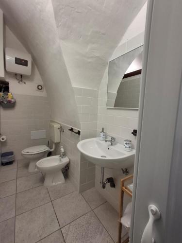a bathroom with a toilet and a sink at La casa del Belvedere in Grassano