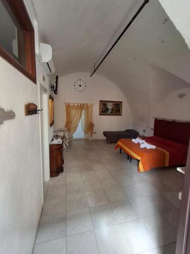 a bedroom with a bed and a couch in a room at La casa del Belvedere in Grassano