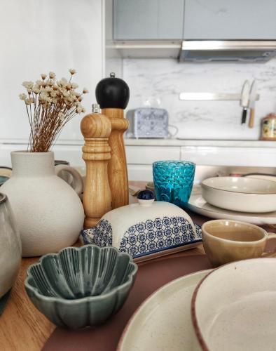 a counter with bowls and vases on a table at Light Blue Apartment Orihuela Costa in Orihuela Costa