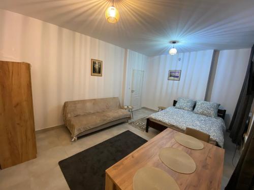 a living room with a couch and a table at Mossmarken Stay in Warsaw