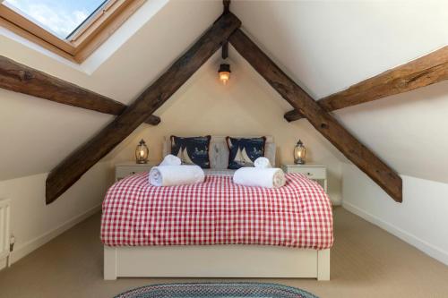 a bedroom with a bed in a attic at Sandpiper Alnmouth in Alnmouth