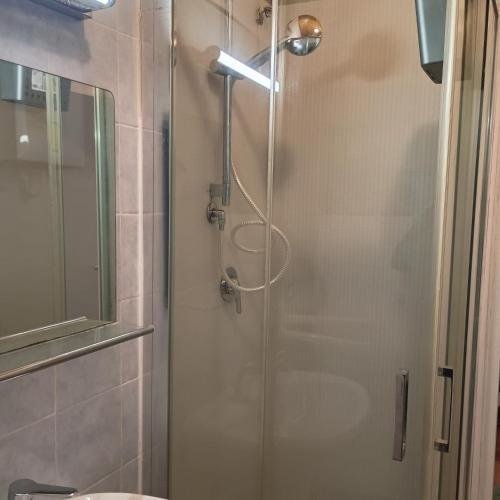 a shower with a glass door in a bathroom at La Casa del Zuf in Carlino
