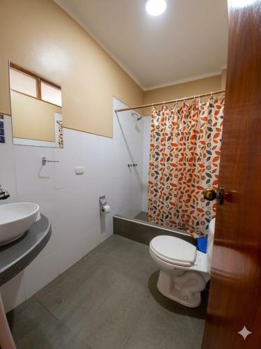 a bathroom with a toilet and a sink at La Posada de Gocta in Cocachimba
