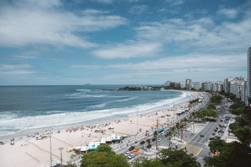 a view of a beach with people and the ocean at Pestana Rio Atlantica in Rio de Janeiro