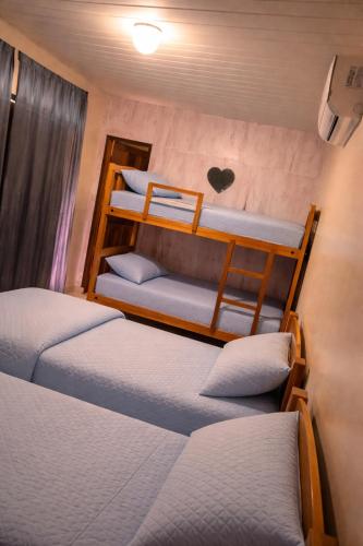 a bedroom with three bunk beds with a heart on the wall at Aguas de Alter in Santarém
