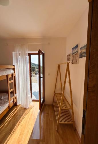 a room with a staircase and a window at Apartment ADEPTO in Sveti Jakov