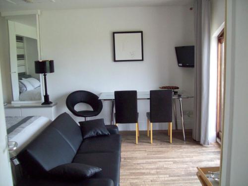 a living room with a couch and two chairs at WILLOW BARN boutique B&B in Worle