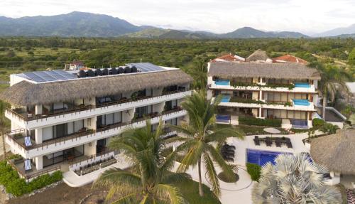 an aerial view of the resort with mountains in the background at El Secreto Residencial in Zihuatanejo
